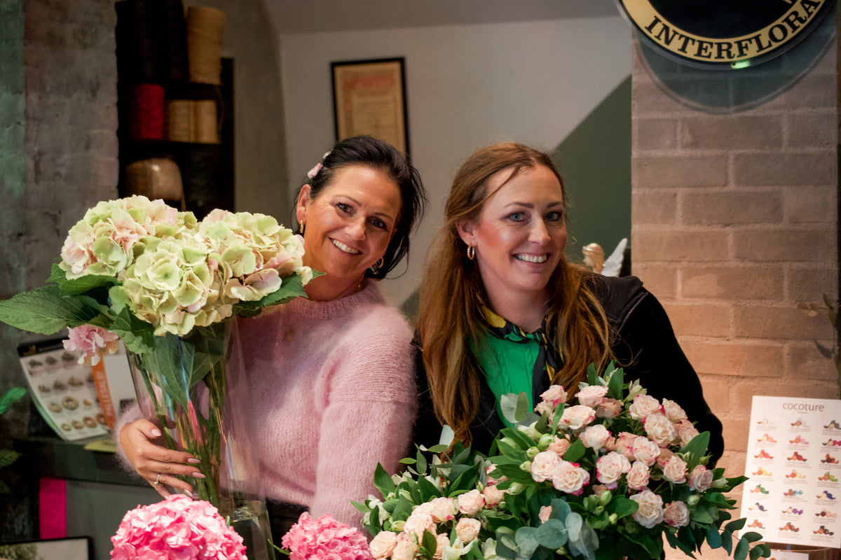 Kvinner med blomster i blomsterbutikk